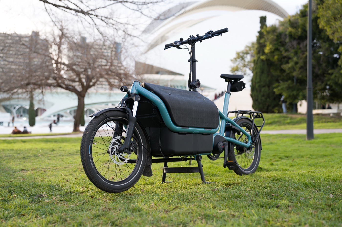 The Clover Duo cargo bike parked on grass with the front box closed